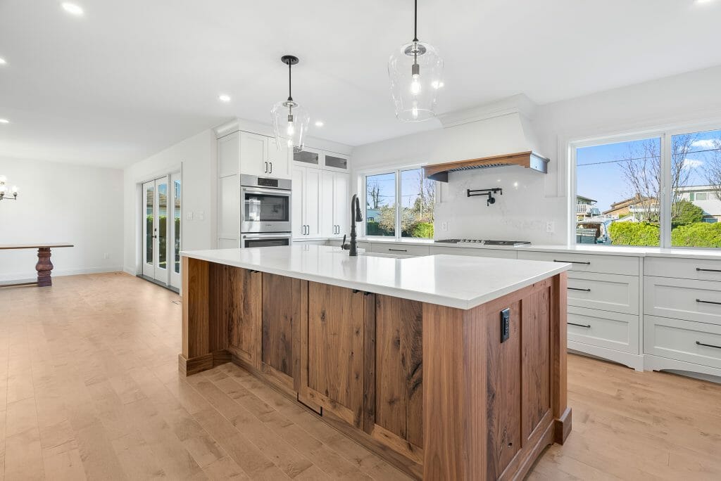 Panoramic view a newly renovated kitchen and French doors leading to the backyard.